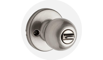 Kwikset Polo Collection Knob product isolated on top of a gray circle